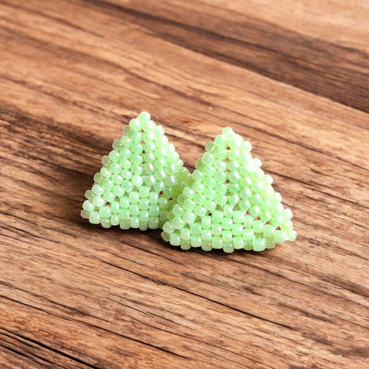 Handmade Pyramid Stud earring in lime green with a sleek triangular design on a wooden backdrop.